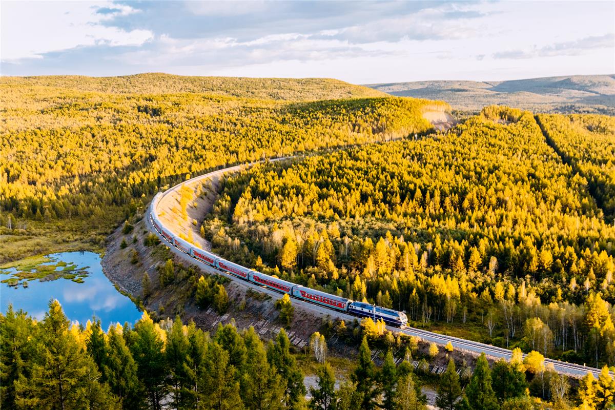 The Hulunbuir train bends through the mountains and forests